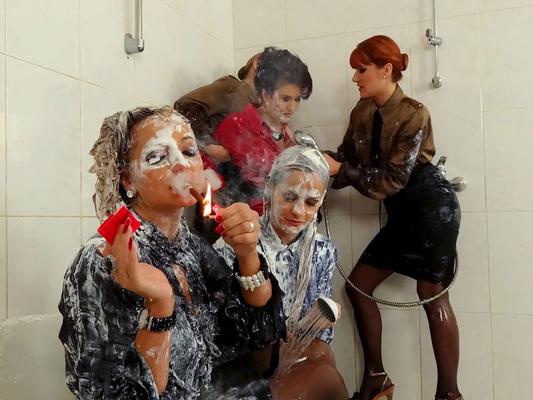 15P Fully clothed women wash the gunk off of a couple of other women in a shower