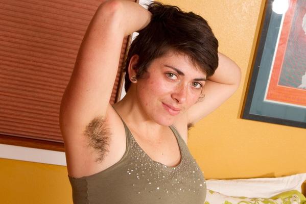 12P Solo girl with short hair proceeds to show hairy pits and bush as she disrobes