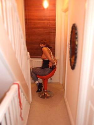 16P Redhead female is tied up in various pairs of pantyhose while ball gagged