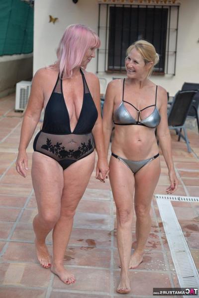 20P Mature blonde women frolic in a swimming pool with their swimsuits on