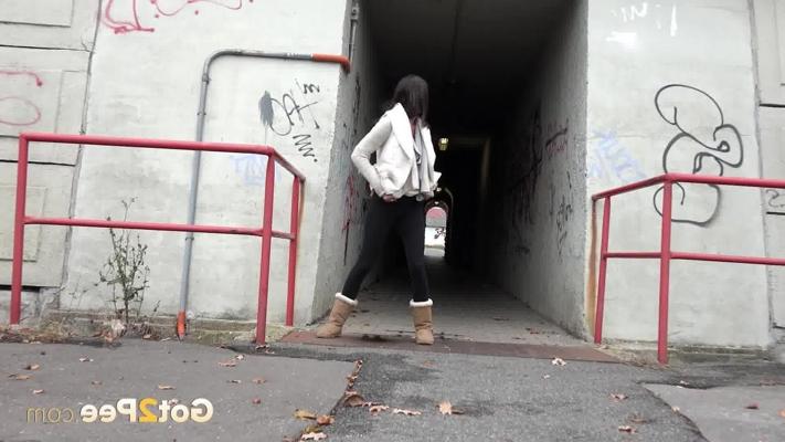 15P Brunette girl Eveline Neill gets caught pissing at a tunnel entrance in UGGs