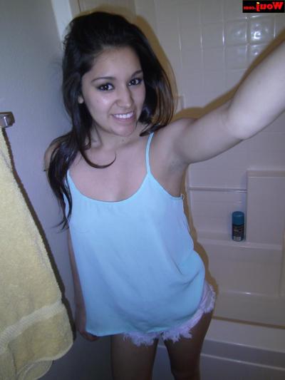 15P Little brunette babe showing off her big booty in her denim shorts