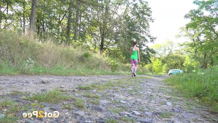 15P European female Valentina Ross squats for a pee while strolling a country road