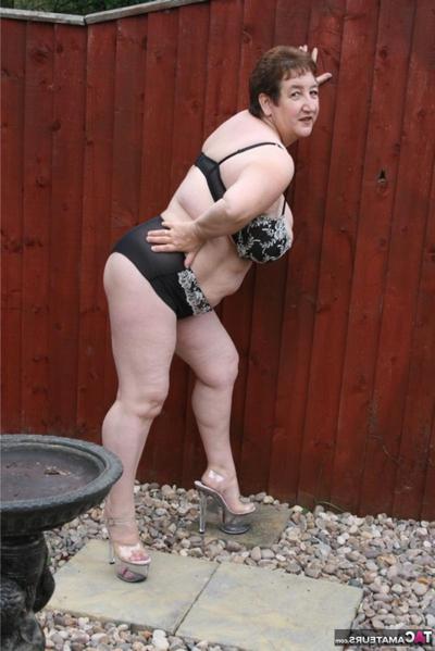 16P Overweight mature British woman Kinky Carol strips to her lingerie in a yard