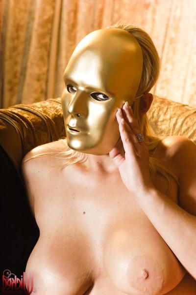 20P Curvy MILF Abbey Brooks poses naked while holding a golden face mask