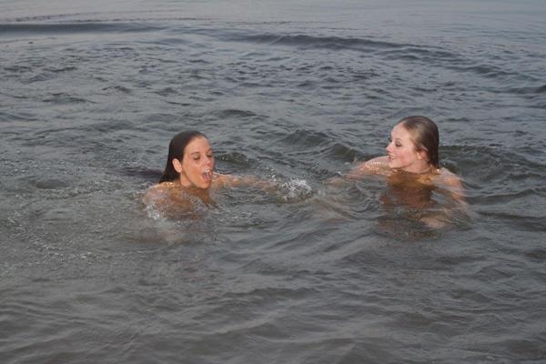 20P Lovely amateur teens in bikinis cuddling and scissoring by the water