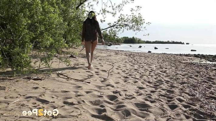 15P Dark-haired girl Anarid lies back on a sandy beach while taking a piss