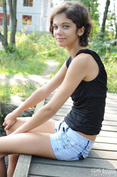20P Pretty dark haired Tina removes her black dress by the pond to show tiny tits
