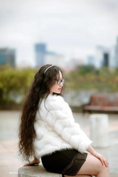 20P Pretty Asian babe with eyeglasses posing in her fur coat and dress outdoors