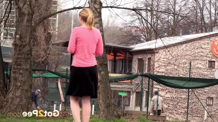 15P Girl with strawberry blonde hair hikes her skirt to pee on lawn on a dare