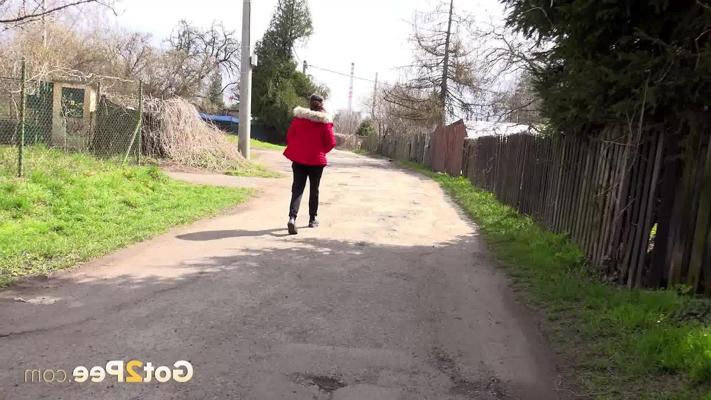 15P Caucasian female Ali Bordeaux squats for a piss against a wooden fence