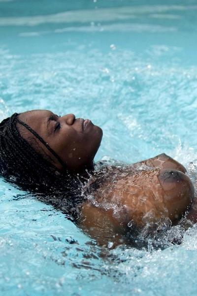 20P Glamorous ebony teen Deserea bares her incredible big tits poolside
