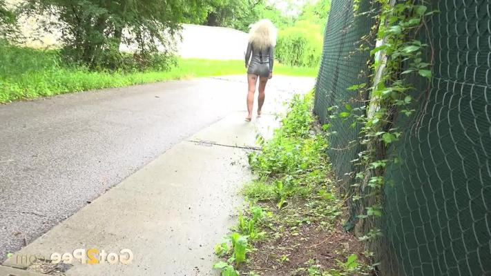 15P Blonde girl Caroli squats before pissing on a paved road lined with trees