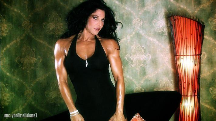 20P Brunette bodybuilder Tracy Daniels displays her tanned body in a sexy dress