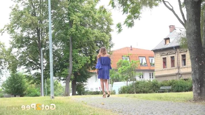 15P Caucasian girl Yenna takes a pee near a stone wall during the day