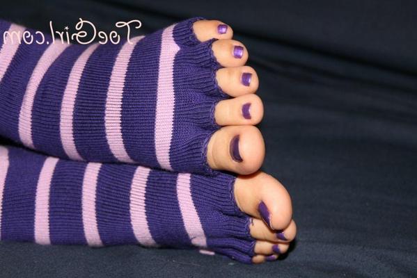 16P Caucasian female displays her painted toenails in toeless socks