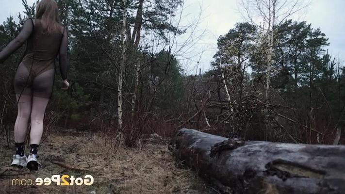 15P Blonde girl Era pisses on a felled tree with a sucker in her mouth