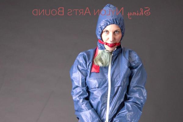 16P Caucasian female is restrained and gagged in a raincoat and rubber boots