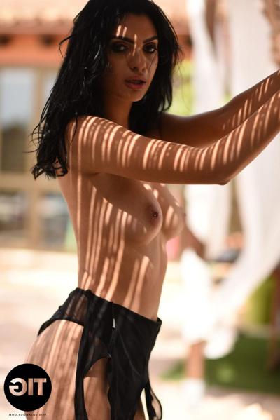 20P Hot black haired babe Sarah Long removes her bodysuit and exposes her tits