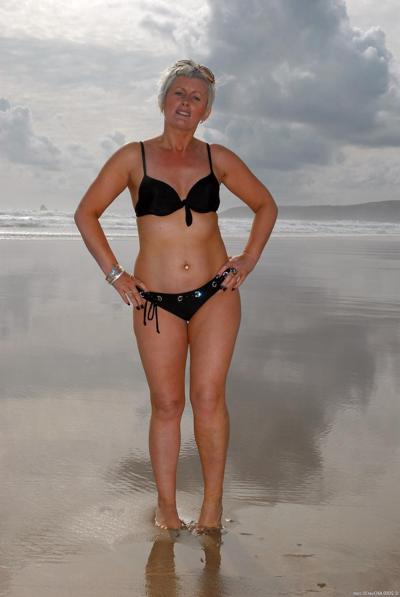 20P Short haired blonde mature Sally T exposes her small nips and pierced pussy