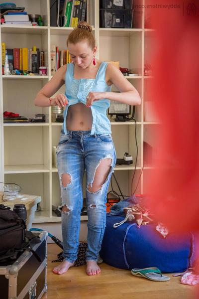 17P Naked redhead pulls on a ripped pair of blue jeans over top of her pretties