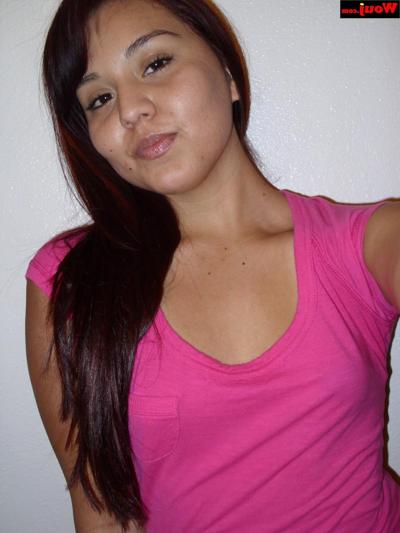 15P Hot Asian babe shows her big booty while posing braless in her pink shirt
