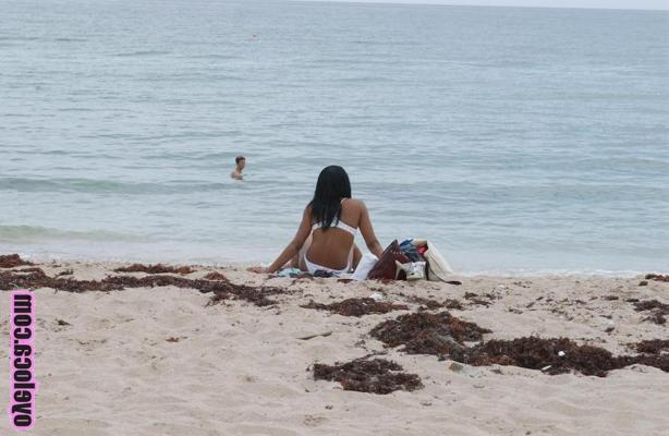 17P Beautiful young ebony Nina Belle with big tits sunning on the beach in bikini