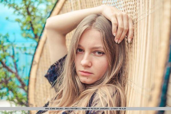 18P Blonde teen Isla undoes her robe to show her naked body on a seaside balcony