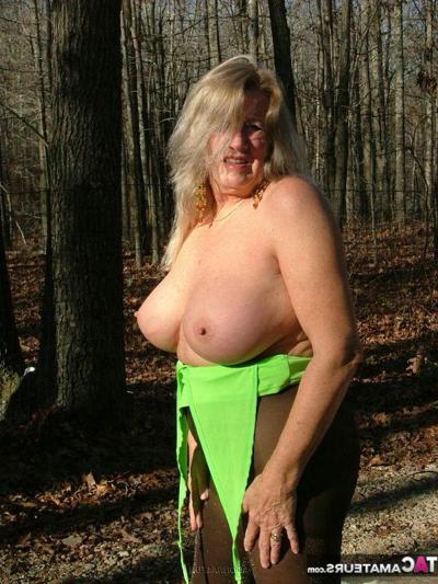 19P Older blonde amateur Adonna unleashes her enhanced boobs near a mature forest