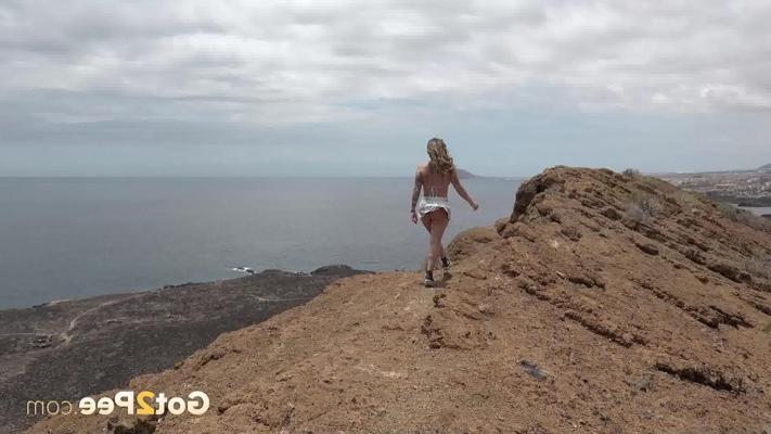 15P Blonde girl Lily takes a pee at altitude with a view of the ocean