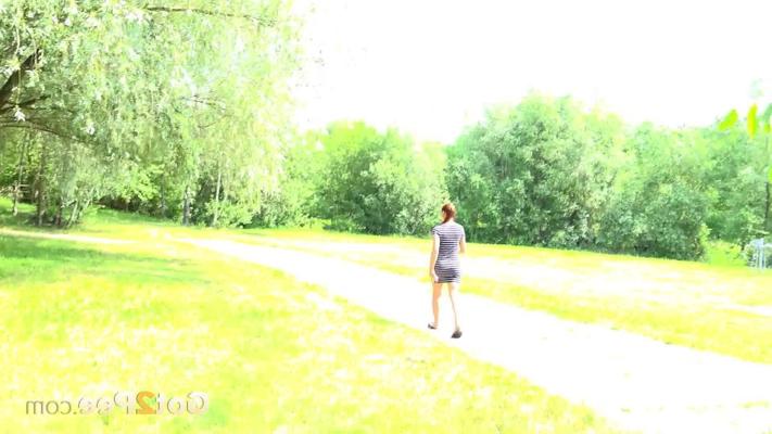 15P Natural redhead Morgan takes a piss under a tree alongside a walking path