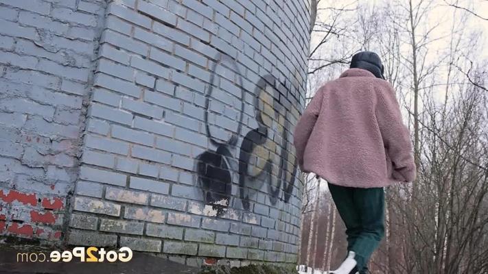 15P Caucasian girl Vasya pisses up against a brick wall in winter clothing