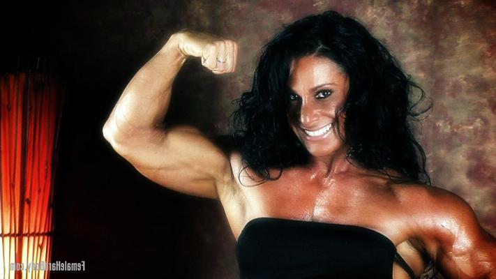 15P Dark-haired bodybuilder Debbie Bramwell flexes her muscles during SFW action