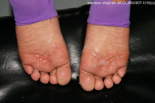 16P Caucasian female shows the bottoms of her feet while sporting jizz upon them