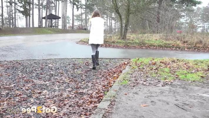 15P Solo girl Cynthia Vellons takes a piss in a gravel driveway on a wet day