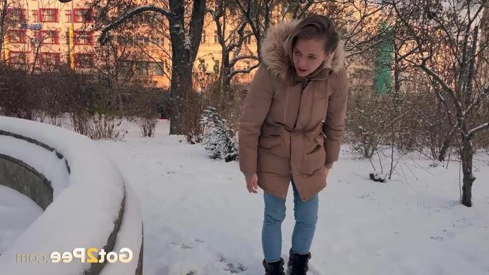 15P Nice girl Juliia pulls down her pants to pee on snow-covered ground in a park