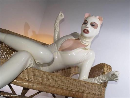 16P Bald female models rubber attire during a solo engagement