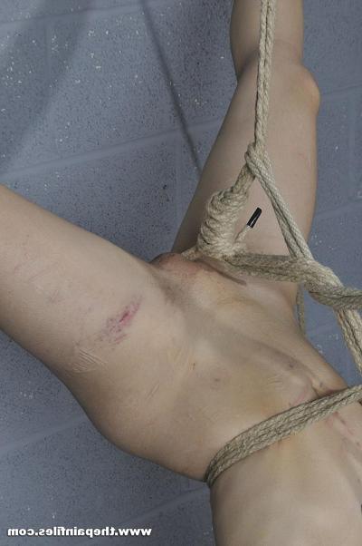 16P Short haired female is suspended upside down by ropes while naked