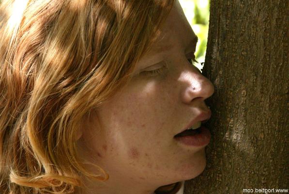 20P Redheaded babe tied to a tree gets spanked by a stranger in the park