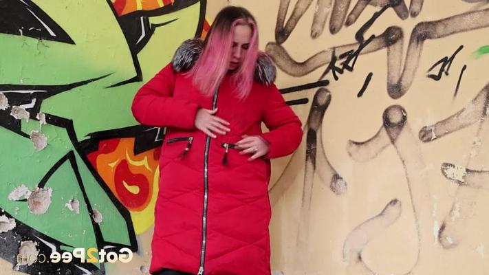 14P Caucasian girl Aura takes a piss up against a wall in winter clothing