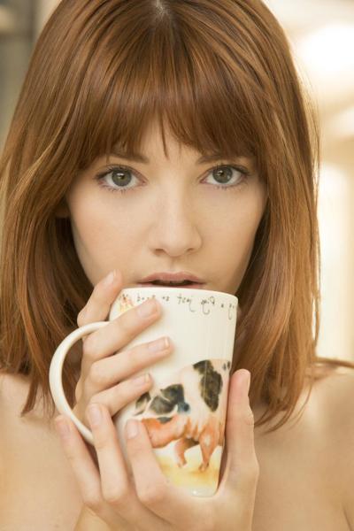 20P Sexy redheaded babe Lena Anderson strips down naked while drinking a coffee