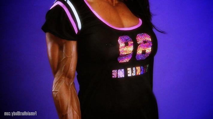 20P Muscular female Marina Lopez exposes her pierced fakes and poses