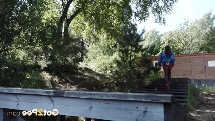 15P Larisa takes a pee over a dock in a denim jacket and high-heeled shoes
