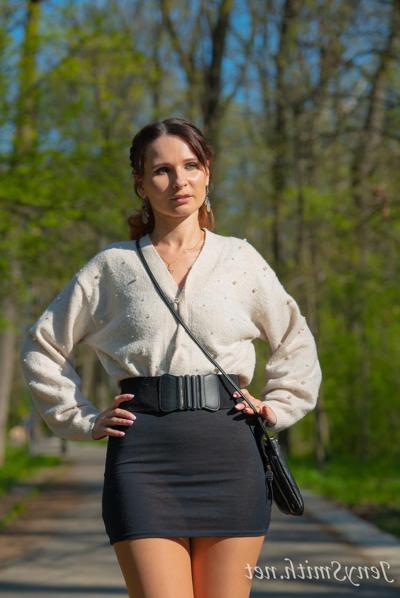 15P Sexy Russian babe Jeny Smith flashes a pantyless upskirt in a sexy black dress