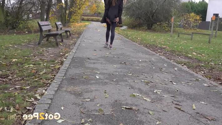 15P Caucasian girl Maddi Black takes a piss up against a tree in a park