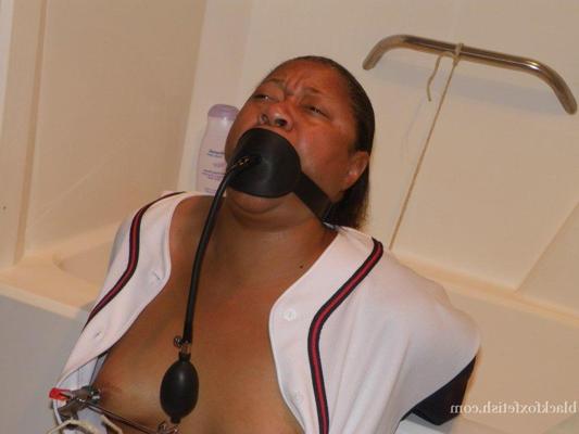 16P Ebony plumper is silenced with a pump up gag while restrained in a bathroom