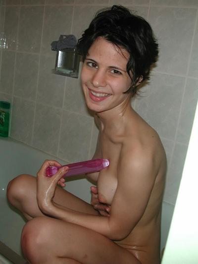 20P Skinny brunette babe Roxanne masturbates with a dildo in the bathroom