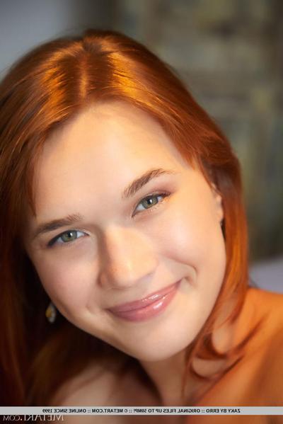 18P Young redhead Zaky removes her lingerie to get totally naked on a bed