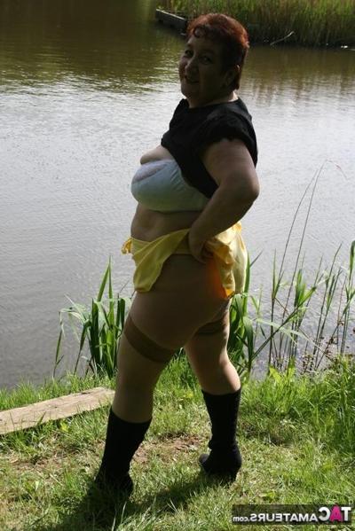 20P Older redhead Kinky Carol exposes her bra and underwear near the water