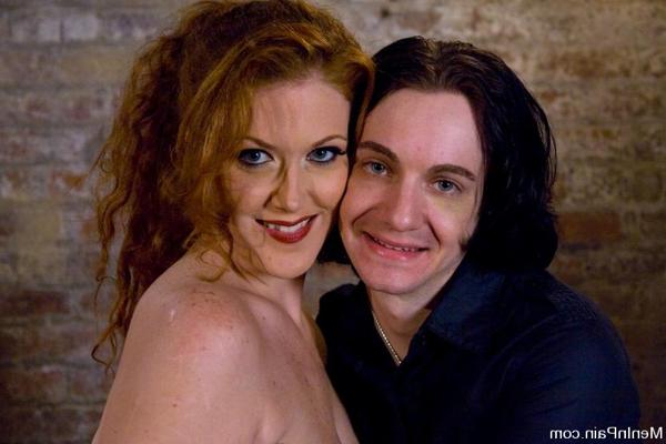 10P Redheaded woman dominates a submissive male in a dungeon setting